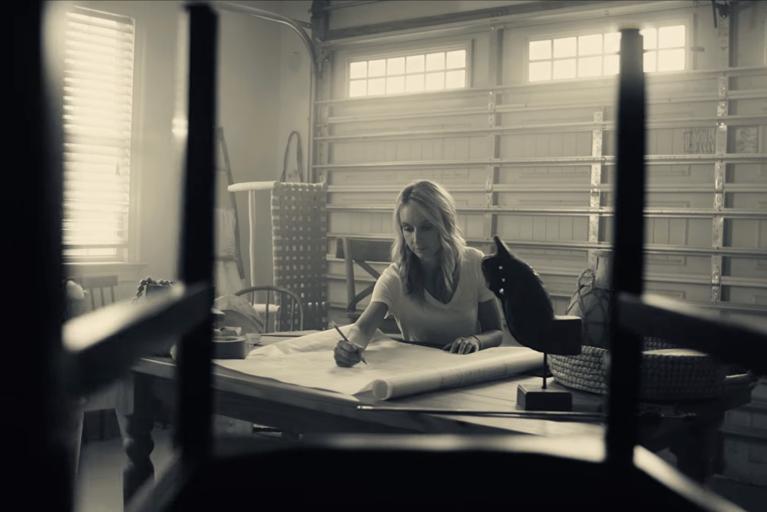 A woman designing business plans in her garage.