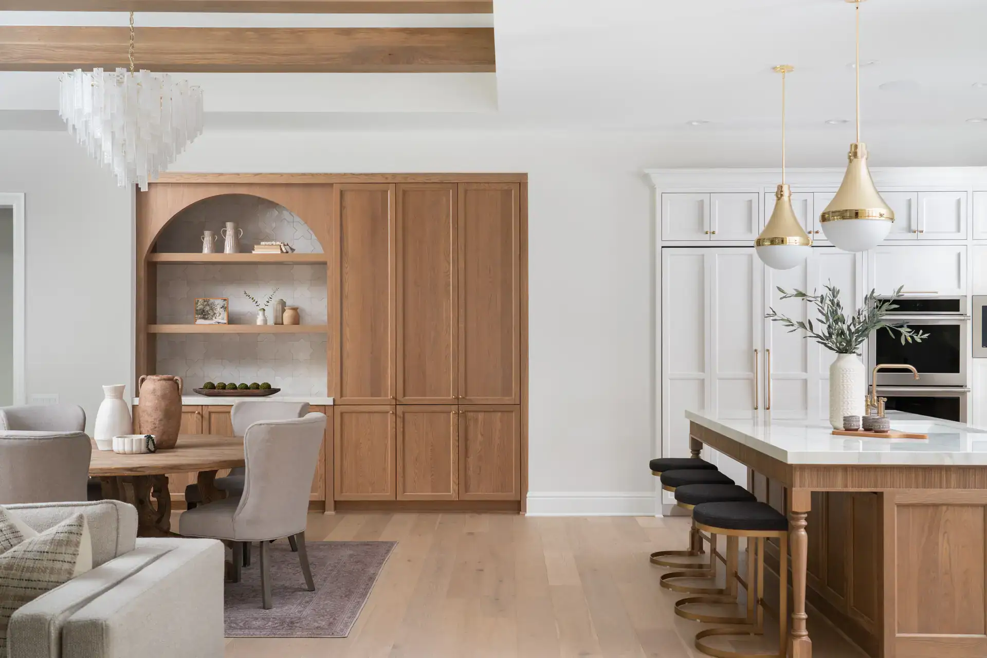 Bright open-concept kitchen and dining space with stylish wooden cabinetry and contemporary decor.