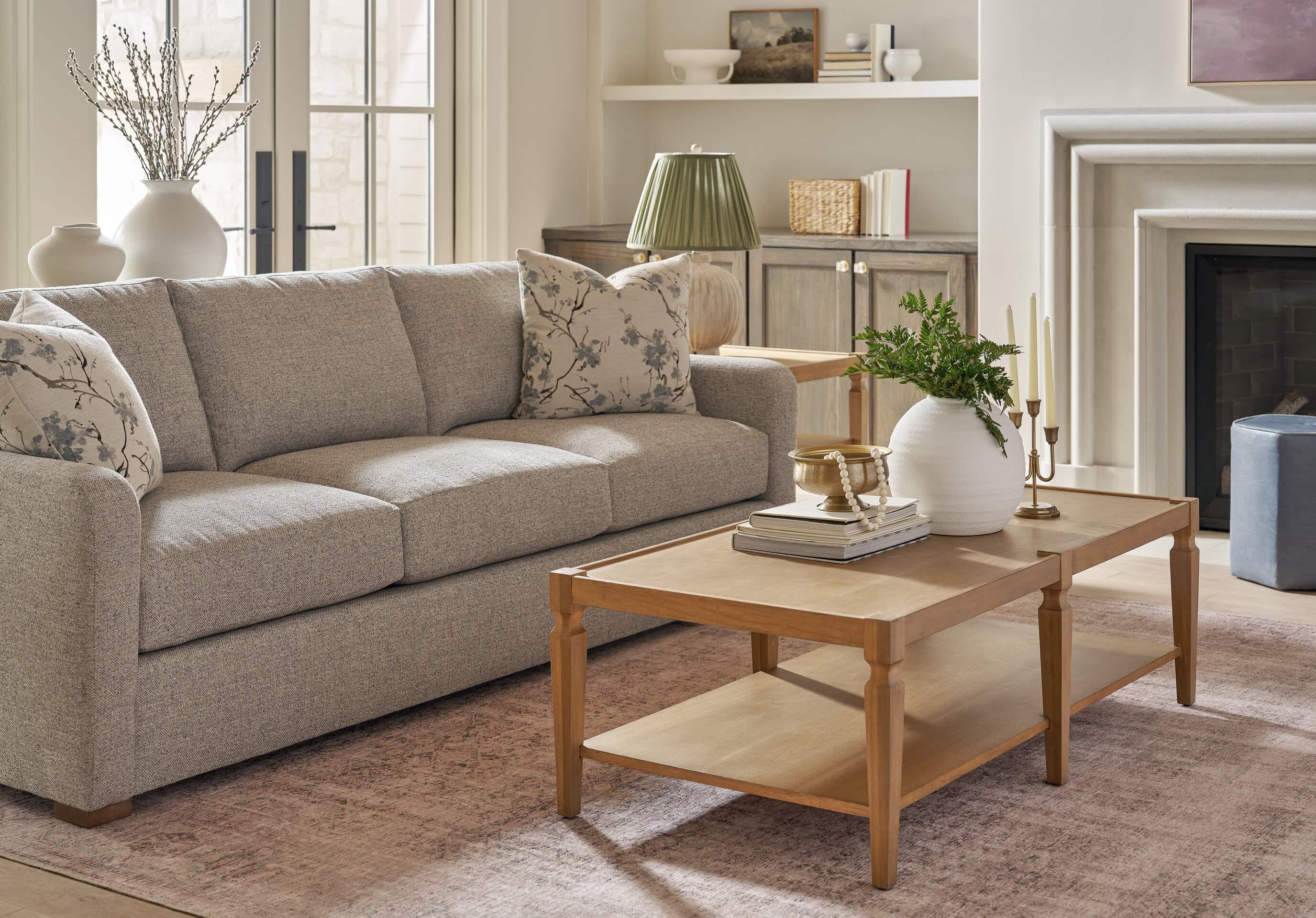 Modern living room with neutral sofa, wooden coffee table, and decorative accents.
