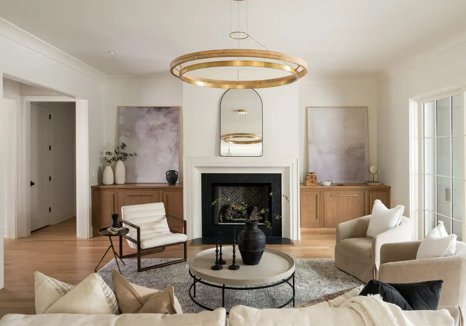 Elegant living room with fireplace, neutral tones, and stylish furniture.